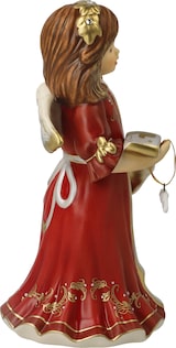 Eine Engelsfigur mit einem roten Kleid und einem Buch.