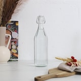 thumbnail of Botella de vidrio con tapa abatible de 1 litro – Botella de agua transparente con tapa abatible – Transparente