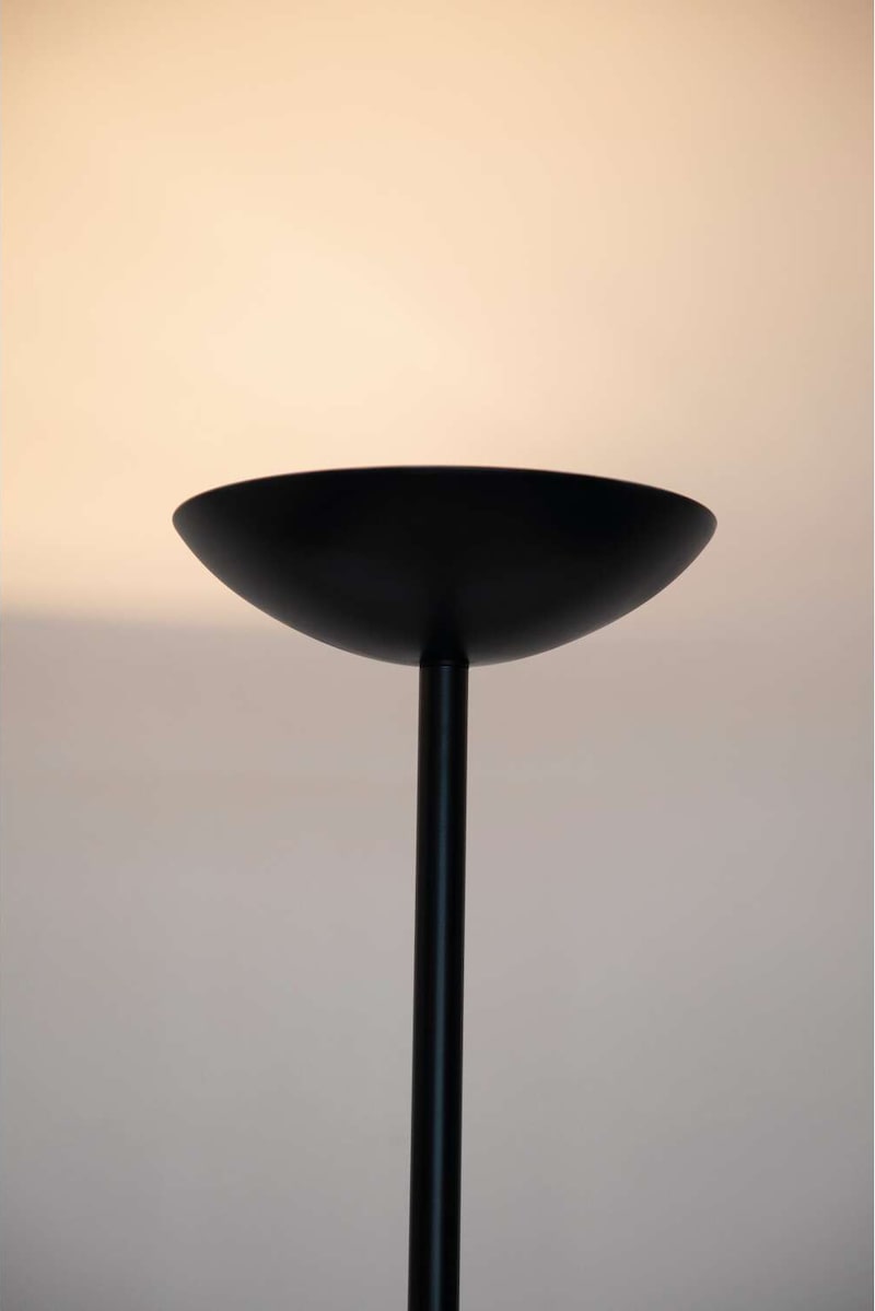 Ein schwarzer Stehlampenschirm mit Licht.
