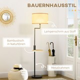 Ein Stehlampe mit einem Lampenschirm aus Stoff und einem Metallrahmen.
