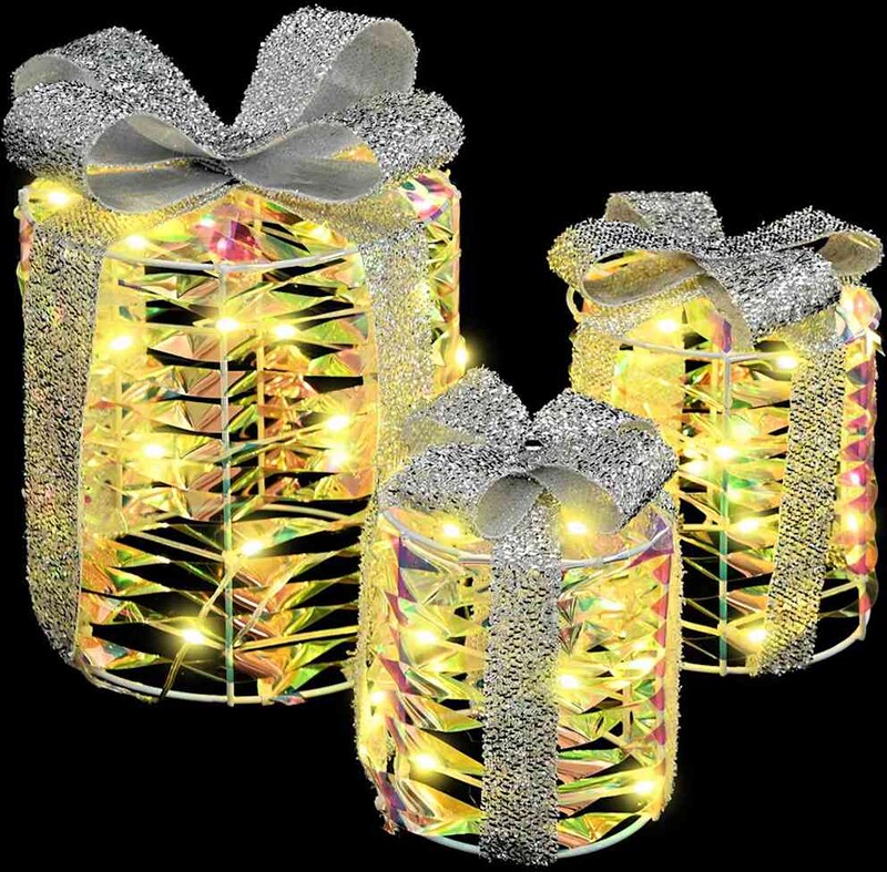 Drei beleuchtete Geschenkboxen mit Schleifen.