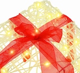 Ein beleuchtetes Geschenk mit roter Schleife.