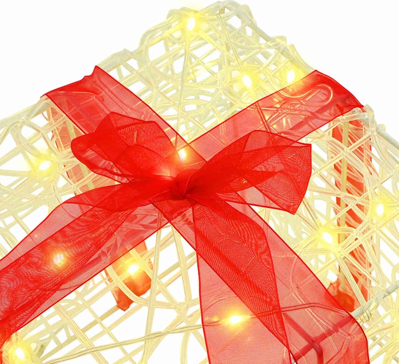 Ein beleuchtetes Geschenk mit roter Schleife.