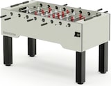 Ein weißer Tischfußballtisch mit schwarzen Beinen.