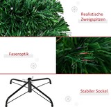Ein künstlicher Weihnachtsbaum mit Lichtern und Ständer.