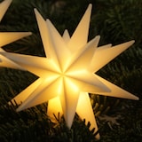 Ein beleuchteter Stern als Weihnachtsdekoration.