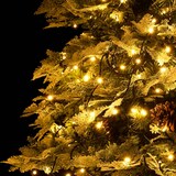 Ein verschneiter Weihnachtsbaum mit Lichtern.