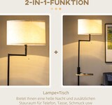Eine Stehlampe mit einem kleinen Tisch.