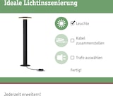 Un lampadaire noir avec câble et prise.