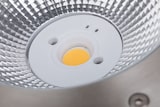Une base ronde et blanche avec une seule LED jaune.