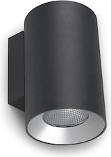 Una lámpara de pared cilíndrica negra con borde plateado.