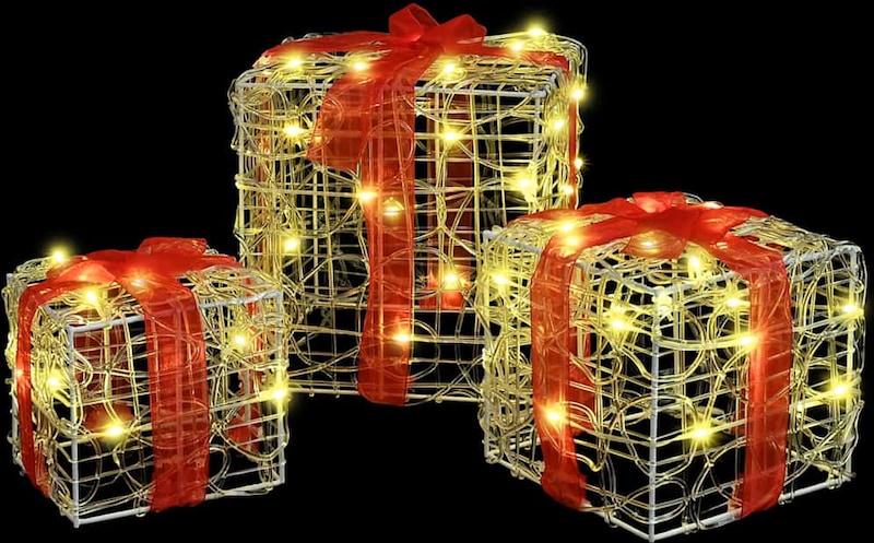 Drei beleuchtete Geschenkboxen mit roten Schleifen.
