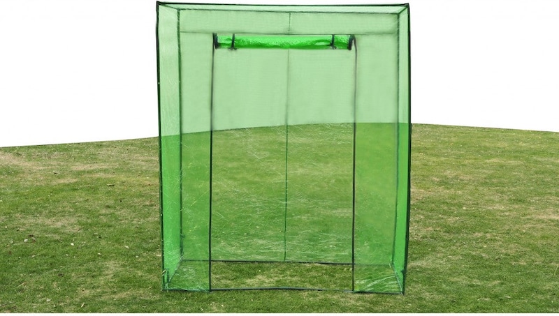 Una serra verde con porta con cerniera.