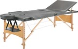 Ein grauer Massagetisch mit verstellbarem Kopfteil.