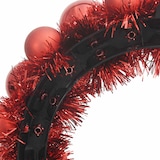 Ein Stirnband mit roten Weihnachtskugeln und Lametta.