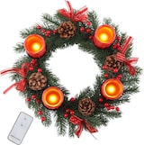 Ein Adventskranz mit Kerzen und Zapfen.