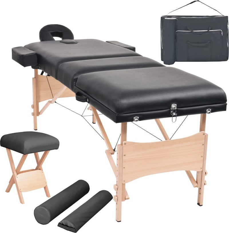 Ein schwarzer Massagetisch mit Zubehör.