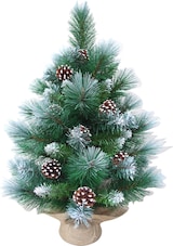 Un piccolo albero di Natale artificiale con pigne.