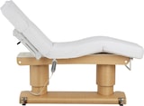 Ein verstellbarer Massagetisch mit weißer Polsterung.