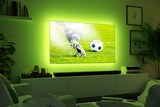 Ein Fernseher mit grünem Licht im Hintergrund.