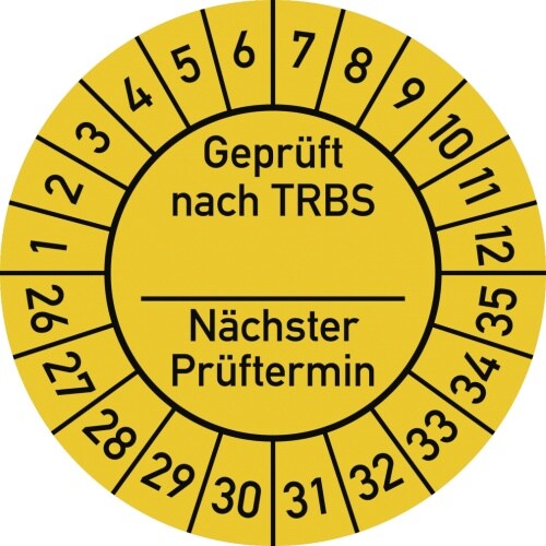 Ein runder gelber Aufkleber mit schwarzen Markierungen.
