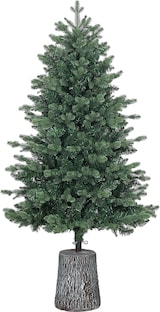 Un albero di Natale artificiale in un supporto per albero.